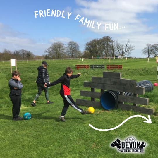 Children playing the wooden obstacles on the football golf course